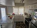 Bright kitchen featuring white cabinets, laminate countertops, and stainless steel appliances at 4614 N 19 Ave, Phoenix, AZ 85015