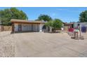 Wide view of single-story home and desert-landscaped front yard with charming curb appeal at 4808 W Shaw Butte Dr, Glendale, AZ 85304