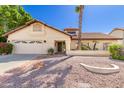 Charming single Gathering home with desert landscaping and a two car garage at 6122 E Saddleback St, Mesa, AZ 85215