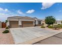 Charming single-Gathering home with a well-maintained yard, three-car garage, and stone accents at 681 W Belmont Red Trl, San Tan Valley, AZ 85143