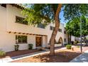 Side view of a charming two-story home with unique architectural details and mature trees at 7665 E Montecito Ave, Scottsdale, AZ 85251