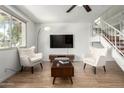 Inviting living room with wood floors, a stylish seating arrangement, and ample natural light at 7665 E Montecito Ave, Scottsdale, AZ 85251