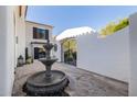 Beautiful courtyard with a fountain and iron gate in this exquisite property at 7838 N 54Th Pl, Paradise Valley, AZ 85253