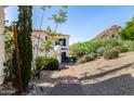 Landscaped desert yard leading to a beautiful white home with mountain views at 7838 N 54Th Pl, Paradise Valley, AZ 85253