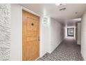 Hallway leading to unit entrance featuring stylish patterned carpet at 7970 E Camelback Rd # 110, Scottsdale, AZ 85251