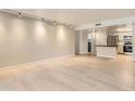 Open living area with light wood floors seamlessly connects to the kitchen at 7970 E Camelback Rd # 110, Scottsdale, AZ 85251