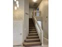 Elegant staircase featuring a modern design and natural light, leading to the upper level at 8732 W Adam Ave, Peoria, AZ 85382