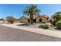 Inviting single-story home featuring a terracotta roof and low-maintenance landscaping at 9123 W Utopia Rd, Peoria, AZ 85382