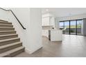 Bright, open-concept living space with modern tile flooring, leading to a white kitchen and outdoor patio at 1 Easy St # 4, Carefree, AZ 85377