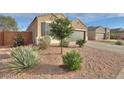 Well-maintained exterior with gravel landscaping, complemented by mature trees and shrubs at 1127 E Tyler Ln, Casa Grande, AZ 85122