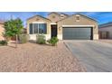 Charming single-story home with a two-car garage and low-maintenance landscaping at 1127 E Tyler Ln, Casa Grande, AZ 85122