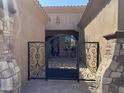 Ornate wrought iron gate providing security and curb appeal to this luxury home at 12937 W Calle De Sol --, Peoria, AZ 85383