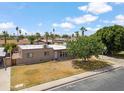 Aerial view of home's front exterior with a spacious driveway, mature landscaping, and a serene neighborhood setting at 1308 S Spur --, Mesa, AZ 85204