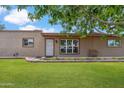Lovely single-story home with a charming front yard and blooming flowerbed at 1308 S Spur --, Mesa, AZ 85204