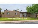 Inviting single-story home with manicured lawn and desert landscaping. Faces east at 1308 S Spur --, Mesa, AZ 85204