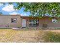 Exterior front facade features a well-manicured garden bed, security door, and a quaint front porch seating at 1308 S Spur --, Mesa, AZ 85204