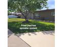 Well-maintained front yard with lush green lawn and automated sprinkler system at 1308 S Spur --, Mesa, AZ 85204