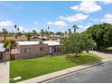 Charming home with a lush front yard and a well-maintained lawn at 1308 S Spur --, Mesa, AZ 85204