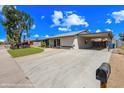 Property boasts a lengthy driveway and covered carport for parking at 1444 W Wickieup Ln, Phoenix, AZ 85027