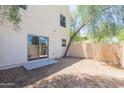 A peaceful backyard featuring gravel landscaping and a mature tree at 15818 N 25Th St # 124, Phoenix, AZ 85032