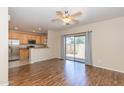 Open concept living room with wood floors, ceiling fan, and backyard access at 15818 N 25Th St # 124, Phoenix, AZ 85032
