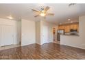 Spacious living room with wood floors, opening to the kitchen with stainless appliances at 15818 N 25Th St # 124, Phoenix, AZ 85032