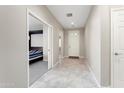 Welcoming foyer with tile flooring and a view into the adjacent bedroom at 16953 W Merrell St, Goodyear, AZ 85395