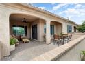 Cozy covered patio with comfortable seating and an outdoor dining area perfect for entertaining at 16953 W Merrell St, Goodyear, AZ 85395