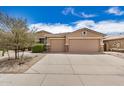 Charming single-story home featuring a three-car garage, desert landscaping, and a welcoming entrance at 17773 W Manso St, Goodyear, AZ 85338