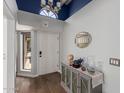 Bright foyer with decorative console table and hardwood floors at 18002 N 12Th St # 45, Phoenix, AZ 85022