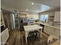 Bright updated kitchen features stainless steel appliances, an island, and a pantry at 1904 E Jarvis Ave, Mesa, AZ 85204