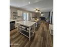 Open concept kitchen with center island flows into the dining and living areas, creating a welcoming space at 1904 E Jarvis Ave, Mesa, AZ 85204