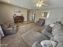Cozy living room with plush seating, a charming piano, and a neutral color palette at 1904 E Jarvis Ave, Mesa, AZ 85204