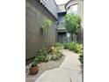 Inviting courtyard with desert landscaping leading to the front door at 19550 N Grayhawk Dr # 2023, Scottsdale, AZ 85255