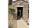 Charming entranceway with stone detail and a desert-friendly landscaped walkway at 19550 N Grayhawk Dr # 2023, Scottsdale, AZ 85255