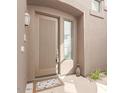 Stylish front door with decorative window, a welcoming mat, and potted greenery at 19550 N Grayhawk Dr # 2023, Scottsdale, AZ 85255