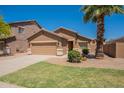 Single-story home featuring desert landscaping, a two-car garage, and a well-maintained front yard at 1956 N Hubbard Ln, Casa Grande, AZ 85122