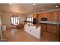 Open kitchen with wood cabinets, granite countertops, stainless steel appliances and eat in breakfast area at 19880 W Desert Views Dr, Casa Grande, AZ 85122