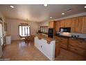Well-equipped kitchen with custom wood cabinets, granite countertops, and stainless steel appliances at 19880 W Desert Views Dr, Casa Grande, AZ 85122