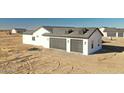 Modern garage with two car spaces, clean lines, and gray doors and trim at 25852 W White Feather Ln, Wittmann, AZ 85361