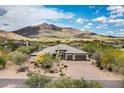Expansive aerial view of desert home showcasing mountain views, privacy, desert landscaping and inviting curb appeal at 35971 N Prickley Pear Rd, Cave Creek, AZ 85331