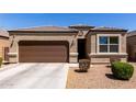 Beautiful single-story home featuring a two car garage and a well-maintained xeriscaped front yard at 36454 W Picasso St, Maricopa, AZ 85138