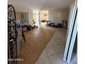 An empty living room featuring tile and hardwood floors and access to additional rooms at 3914 E Andorra Dr, Phoenix, AZ 85032