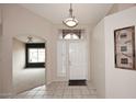 Inviting foyer featuring neutral tile flooring, a transom window, and an art niche at 4081 N 156Th Dr, Goodyear, AZ 85395