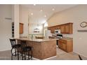 Open kitchen features granite countertops, breakfast bar, and ample cabinet space at 4081 N 156Th Dr, Goodyear, AZ 85395