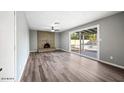 Spacious living room includes brick fireplace and sliding glass door to pool area at 5211 W Beryl Ave, Glendale, AZ 85302