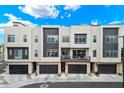 Modern townhome complex with two-car garages and balconies with stylish dark and light grey facade at 6850 E Mcdowell Rd # 29, Scottsdale, AZ 85257