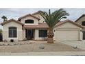 Charming two-story home with well-kept landscaping, desert rock, and a prominent palm tree in the front yard at 7326 W Dreyfus Dr, Peoria, AZ 85381