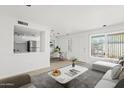 Bright living room featuring wood-look flooring and ample natural light at 7844 E Rovey Ave, Scottsdale, AZ 85250