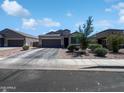 Attractive single-Gathering home with a two-car garage and desert landscaping at 1237 E Paul Dr, Casa Grande, AZ 85122